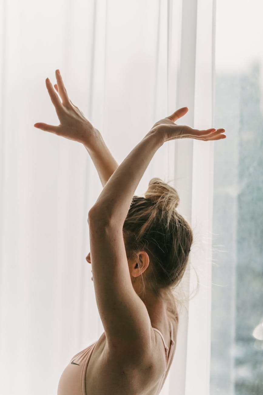 Woman in a graceful yoga pose with aquamarine light accents.